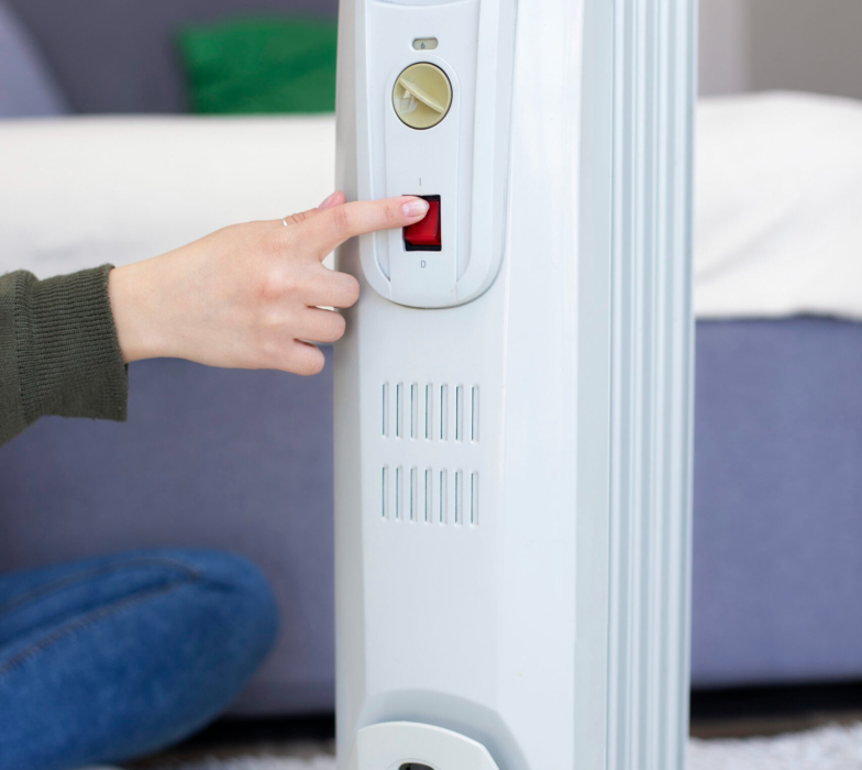 hand-pushing-heater-s-red-button-scaled